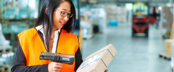 woman scanning parcel using rfid or barcode technology