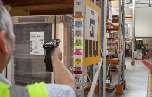 barcode labelling Man scanning racking label in a warehouse